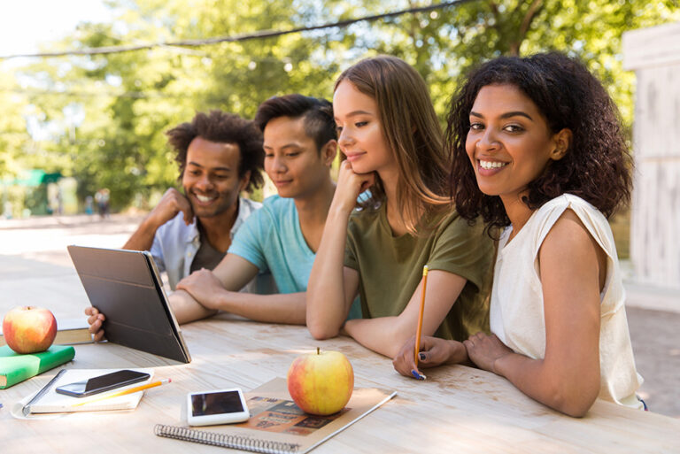 Cheerful african american young man practicing yoga in group